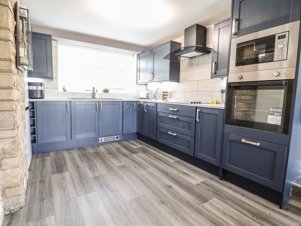 Kitchen with navy shaker units, looking through to the dining area