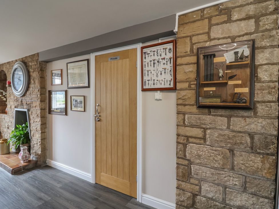 Kitchen corner with exposed stone wall and framed pictures