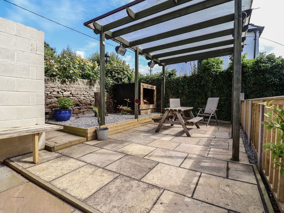 Rear courtyard with pergola, flagstones and seating