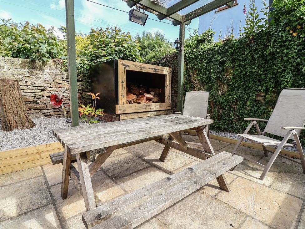 Courtyard table and fire pit under the pergola