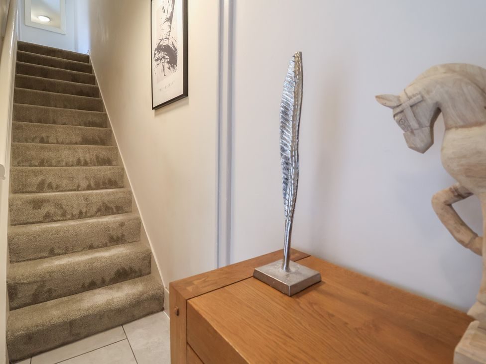 Hallway and stairs with a carved wooden horse